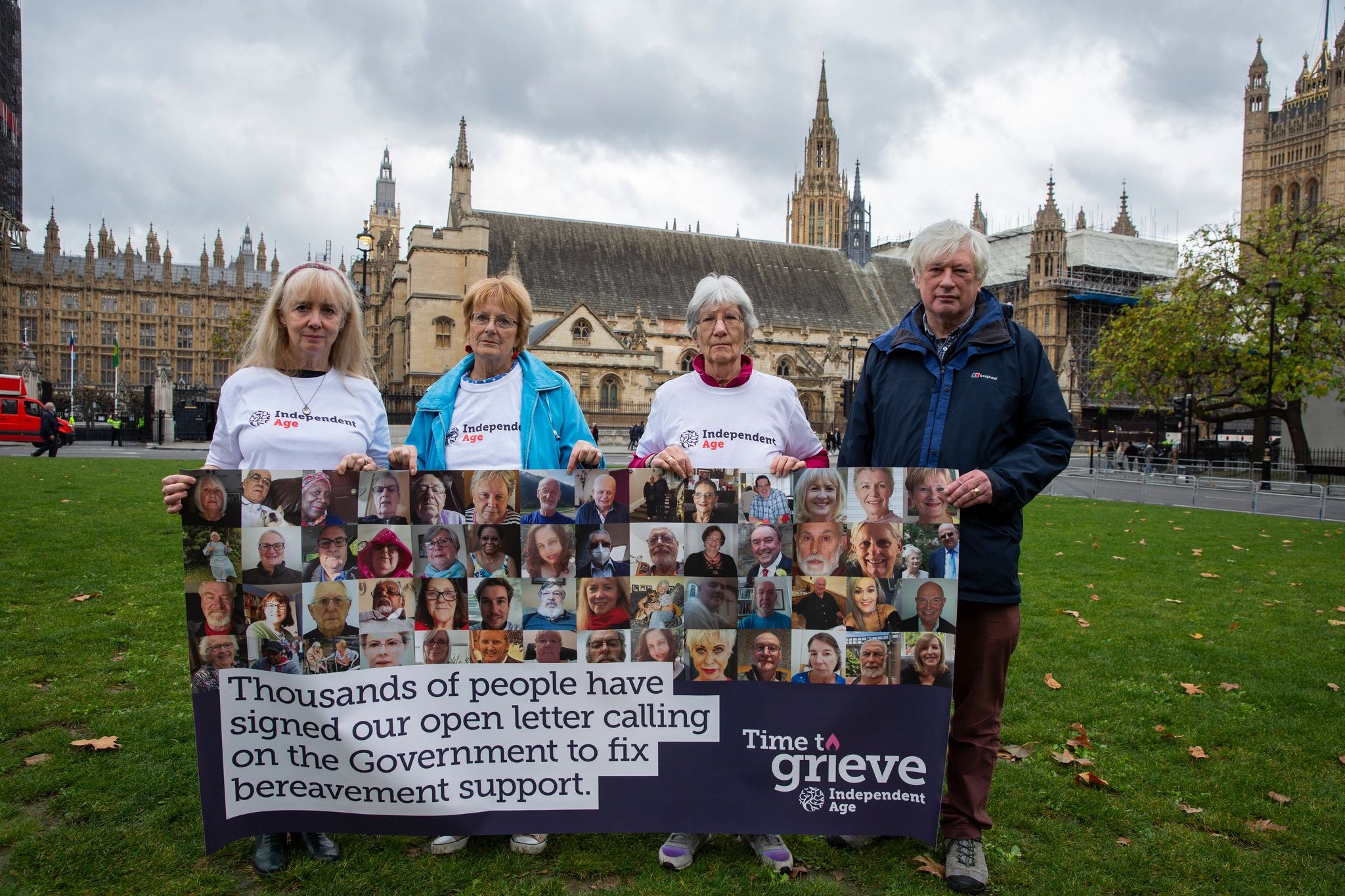Pictured are Paul, Julie, Kathleen and Michaele with a banner featuring some of the people who signed the open letter.
