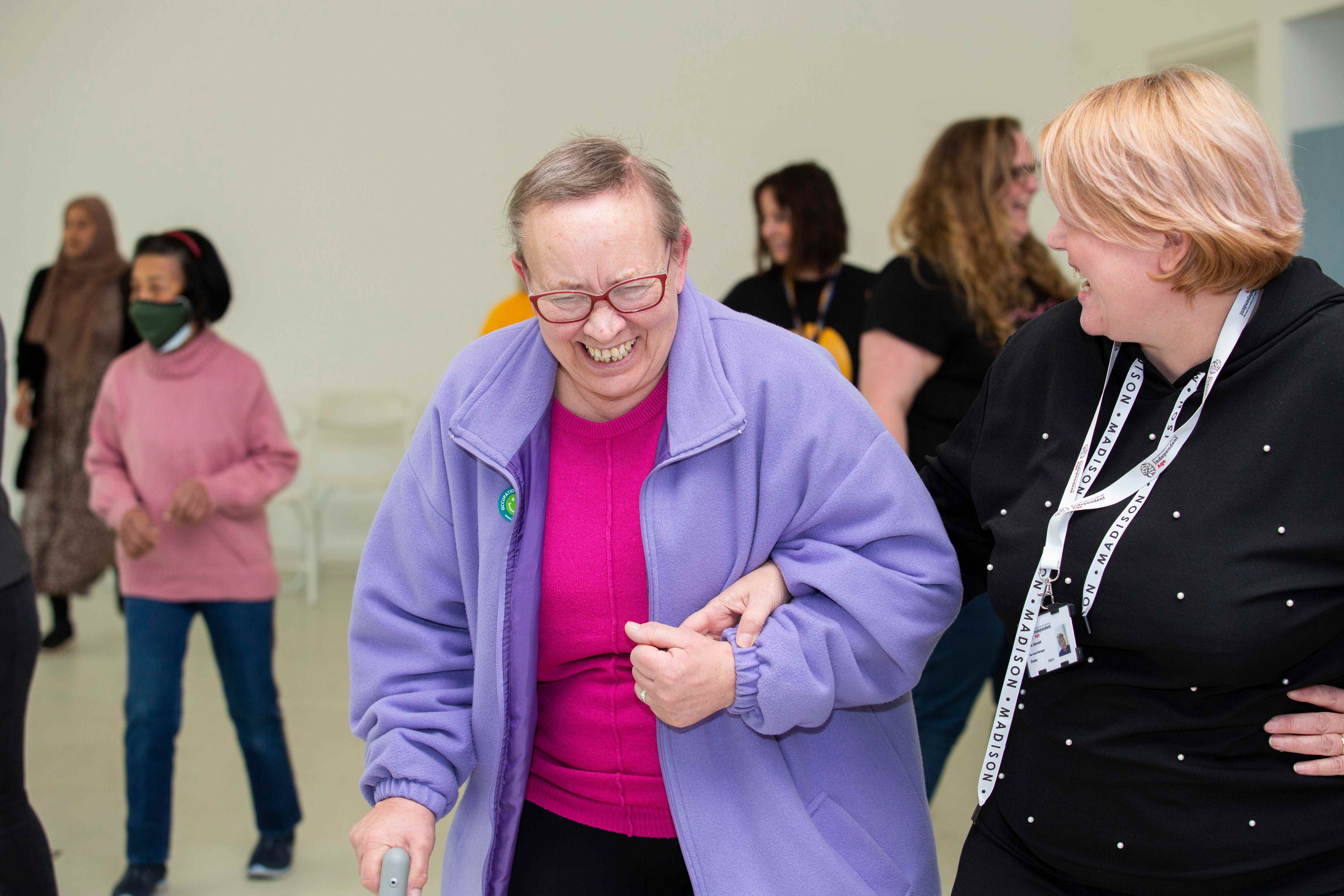 Julianna dancing with Independent Age caseworker