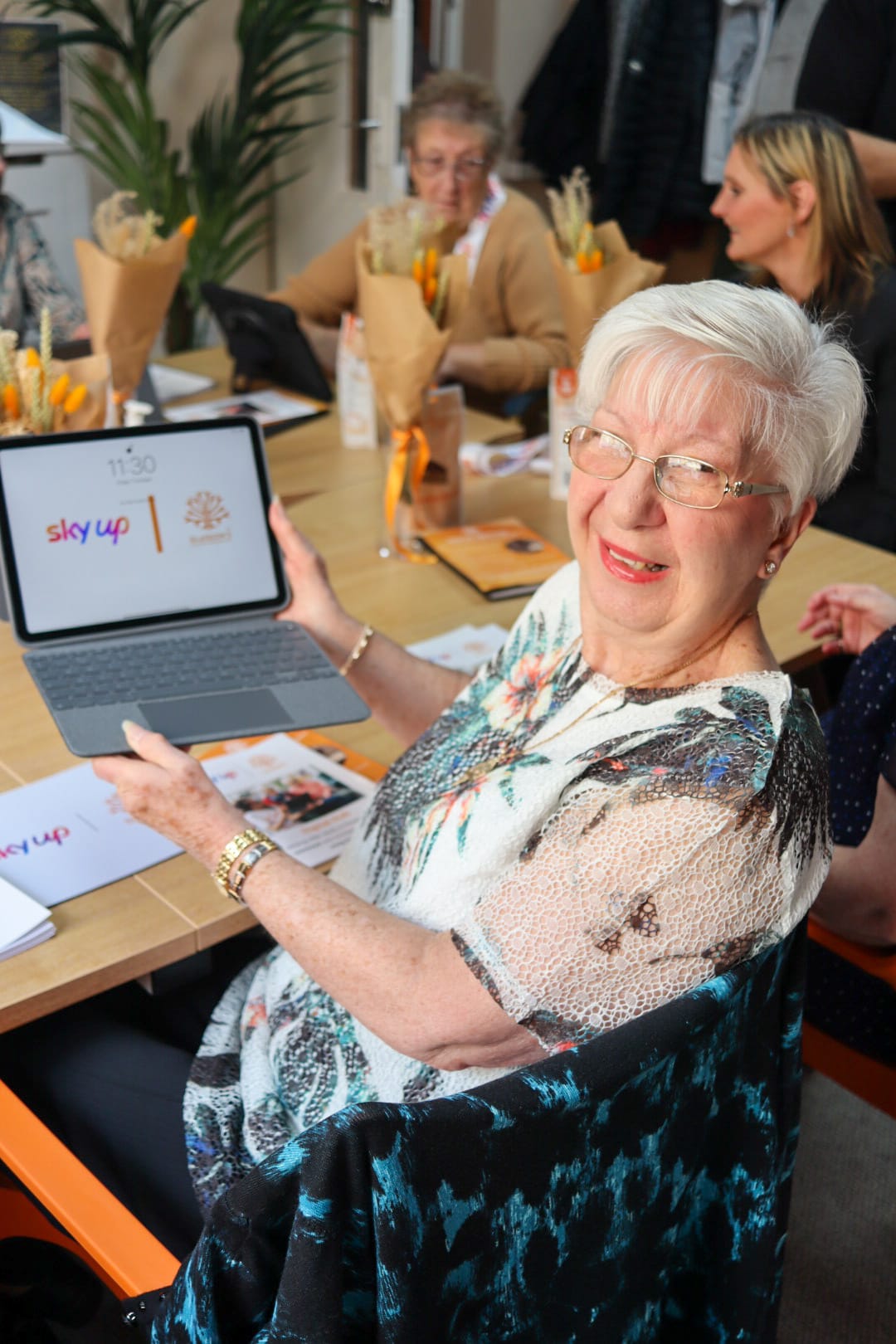 Older woman using laptop and smiling
