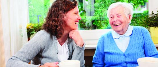Two women sharing a cup of tea and a smile
