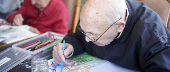 Older man drawing at an art club