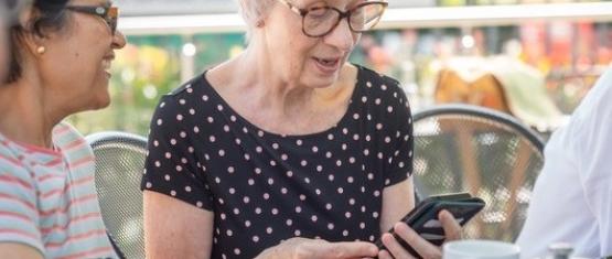 Woman looking at phone in garden centre