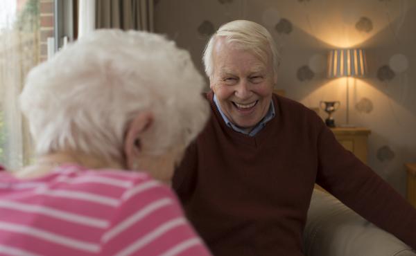 An older man and woman laughing together