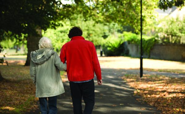 Older woman walking with man in park