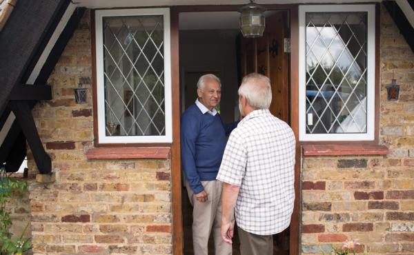 Home owner speaking to man on doorstep