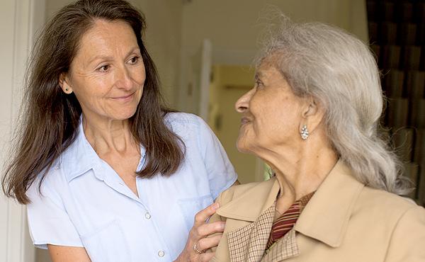 Older woman reassured by her carer