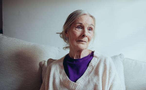 Joan, an older woman, sat alone