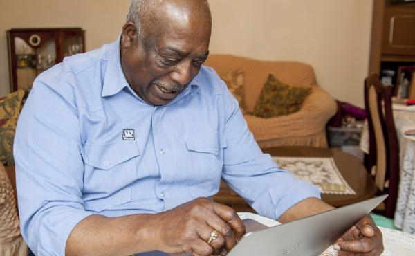 A man reading on a computer