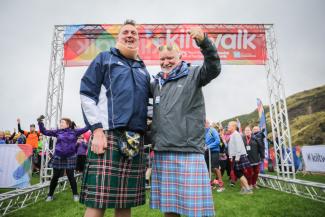 Two men wearing kilts at the finish line