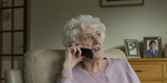 An older woman talks on the phone