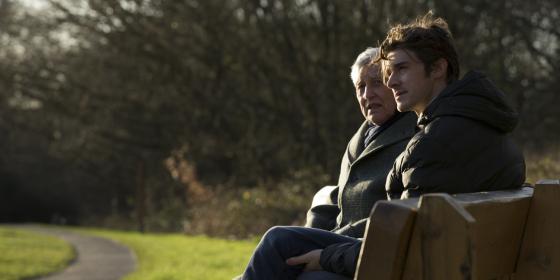 Man and younger man on a park bench
