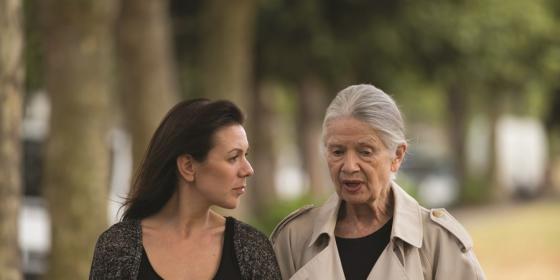 Two women talk as they walk outside