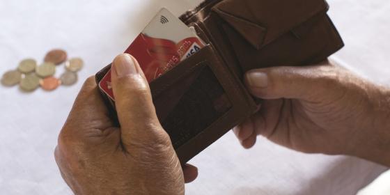 A man flicks through his wallet