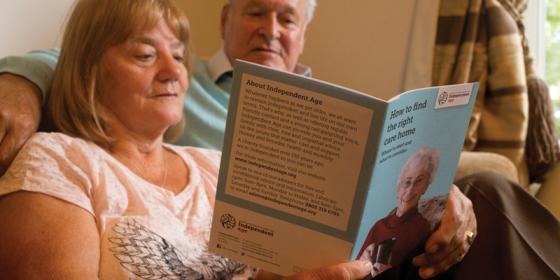 Man and woman looking at care home guide