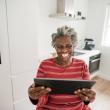 Woman smiling while using a tablet