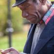 Man looking at smartphone in a park