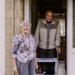 Older couple smiling in their doorway