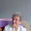 Older woman smiling on sofa