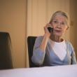 An older woman makes a phone call