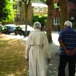 An older woman and man walking together outside