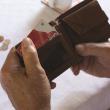 A man flicks through his wallet