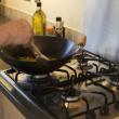 Hand stir frying on a gas hob